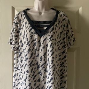 Gray and Cream Colored with nice V Neck Detail. 95% polyester, 5% spandex.